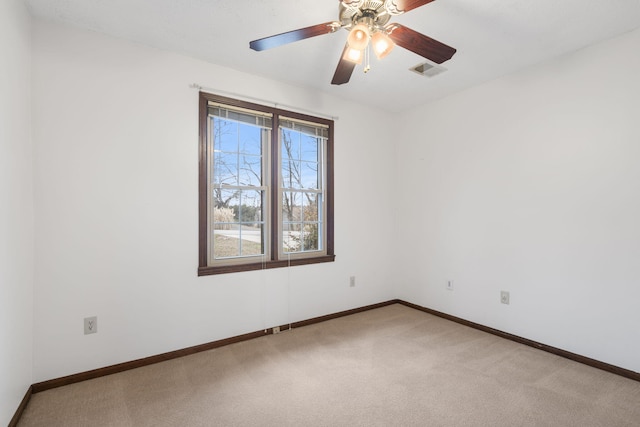 carpeted spare room with ceiling fan