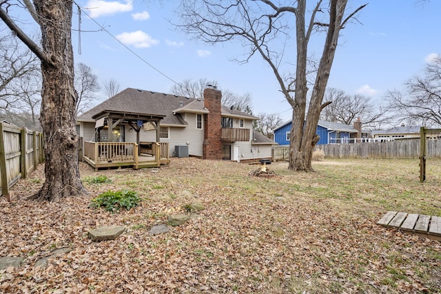 view of yard with central AC unit and a wooden deck