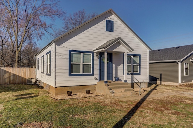 bungalow-style house featuring central AC and a front lawn