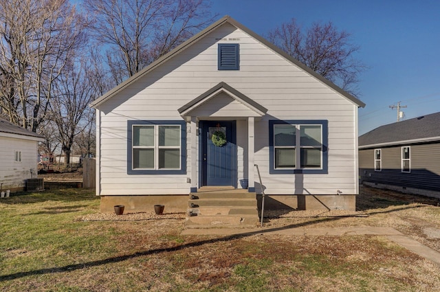 bungalow featuring central AC and a front yard