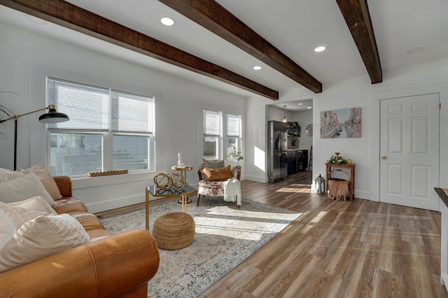 living room with beam ceiling and wood-type flooring