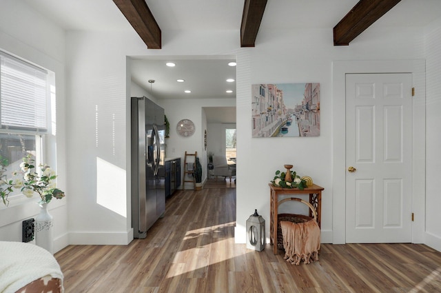 hallway with beam ceiling and hardwood / wood-style flooring