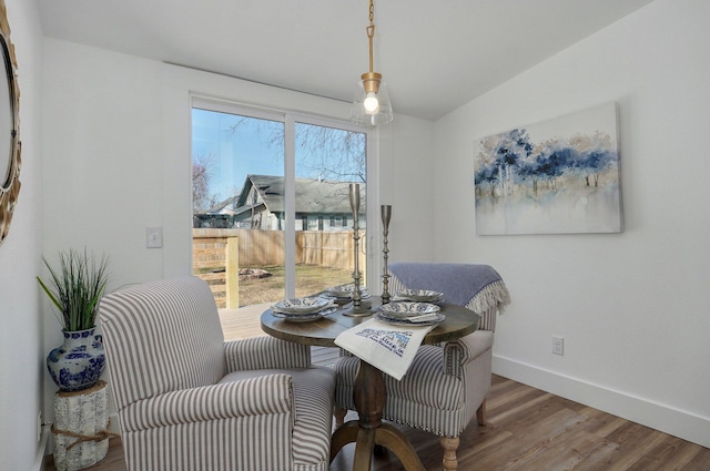 dining room featuring lofted ceiling and hardwood / wood-style flooring