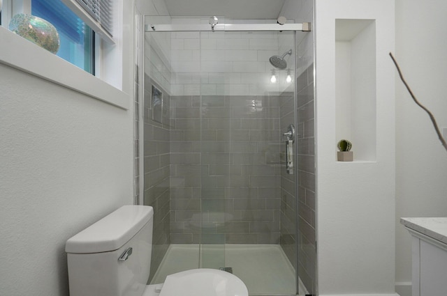 bathroom featuring walk in shower and toilet