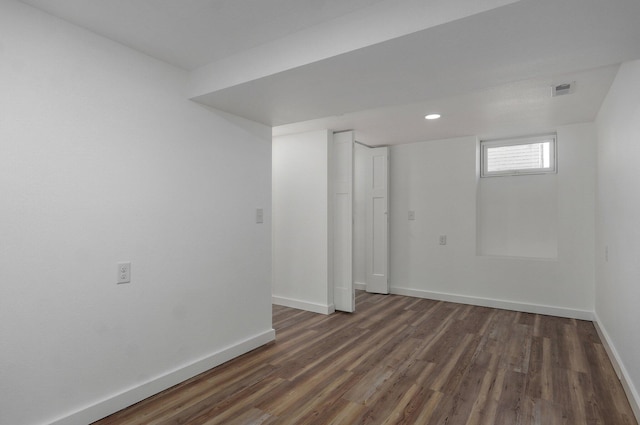 basement with dark hardwood / wood-style flooring