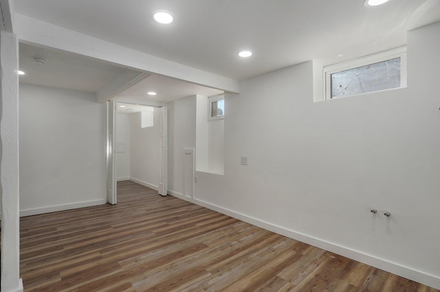 basement with dark hardwood / wood-style flooring