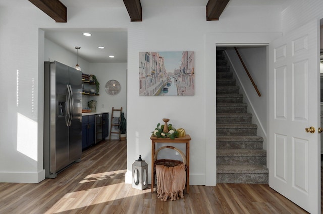 interior space with beam ceiling and dark hardwood / wood-style flooring