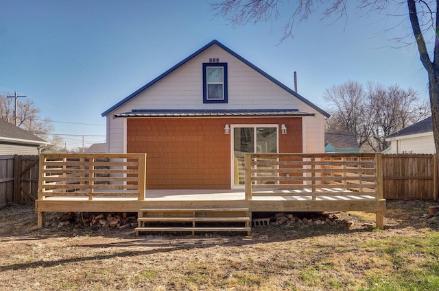 rear view of house featuring a deck