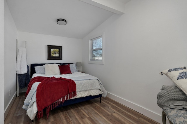 bedroom featuring vaulted ceiling with beams and dark wood-type flooring