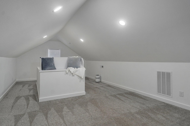 bonus room with carpet floors and lofted ceiling