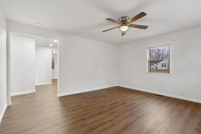 spare room featuring a textured ceiling, ceiling fan, and dark hardwood / wood-style floors