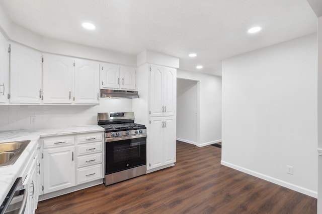 kitchen with white cabinets, dark hardwood / wood-style floors, backsplash, and appliances with stainless steel finishes