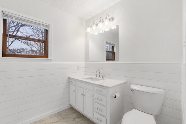 bathroom featuring vanity, a textured ceiling, and toilet