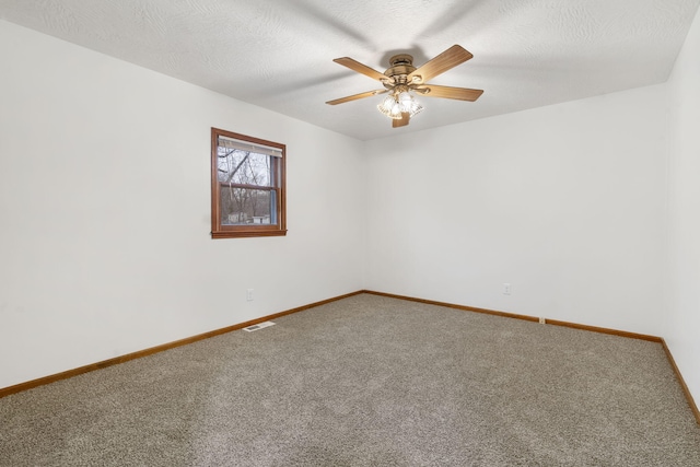 unfurnished room featuring carpet flooring, ceiling fan, and a textured ceiling