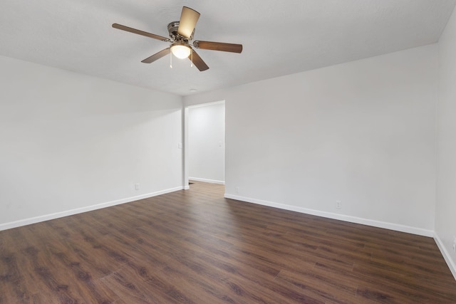 unfurnished room with dark hardwood / wood-style flooring and ceiling fan