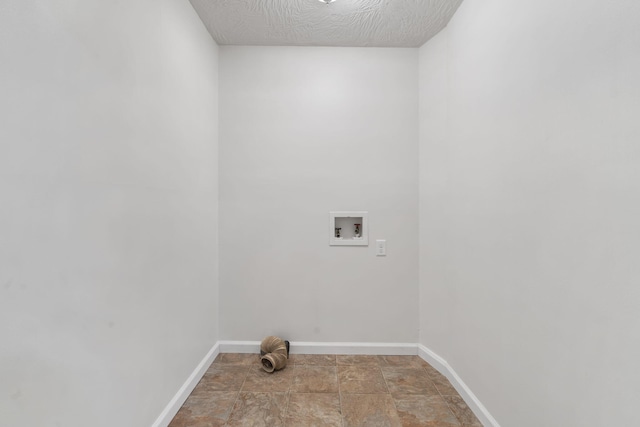 washroom featuring washer hookup and a textured ceiling