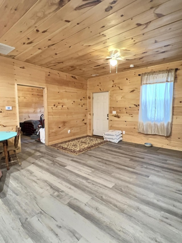 bonus room with hardwood / wood-style floors, wood walls, and wood ceiling