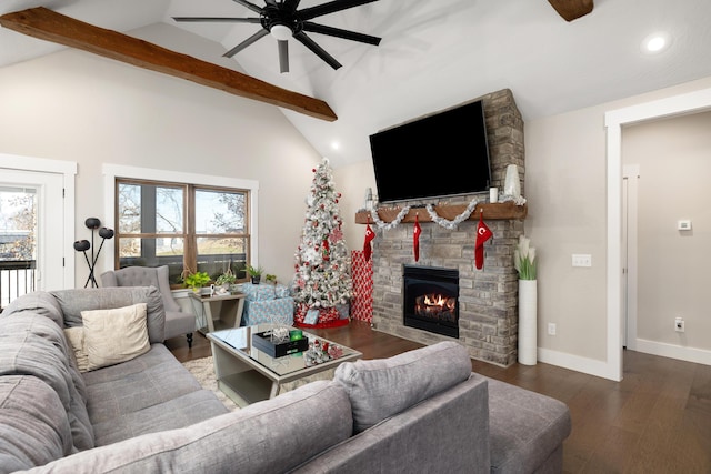 living room featuring dark hardwood / wood-style flooring, vaulted ceiling with beams, a stone fireplace, and ceiling fan