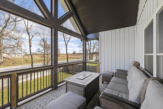 sunroom featuring lofted ceiling