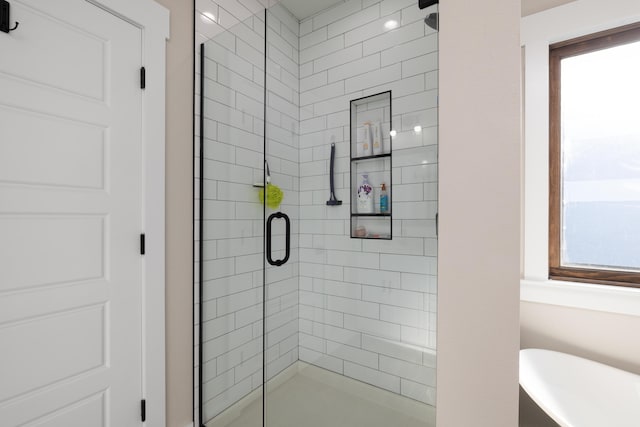 bathroom with shower with separate bathtub and a healthy amount of sunlight