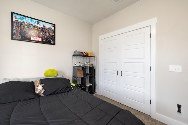 carpeted bedroom featuring a closet