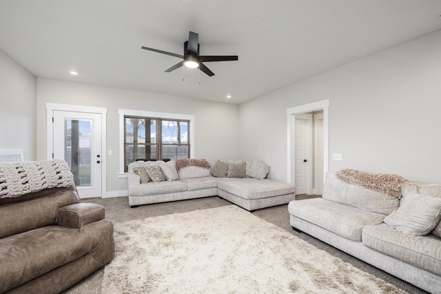 living room with carpet flooring and ceiling fan