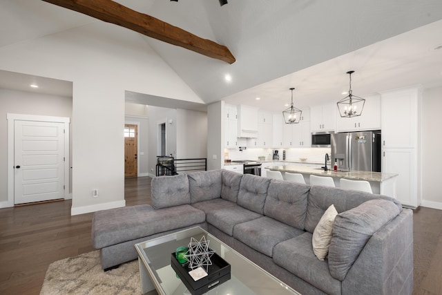 living room with sink, beamed ceiling, dark wood-type flooring, and high vaulted ceiling