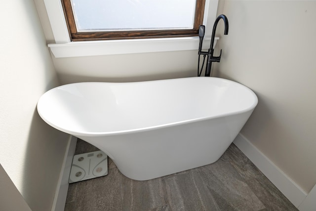 bathroom with a tub to relax in