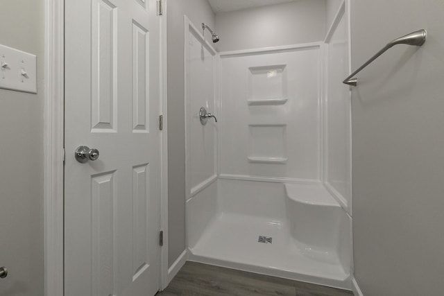 bathroom featuring a shower, a textured ceiling, and hardwood / wood-style flooring