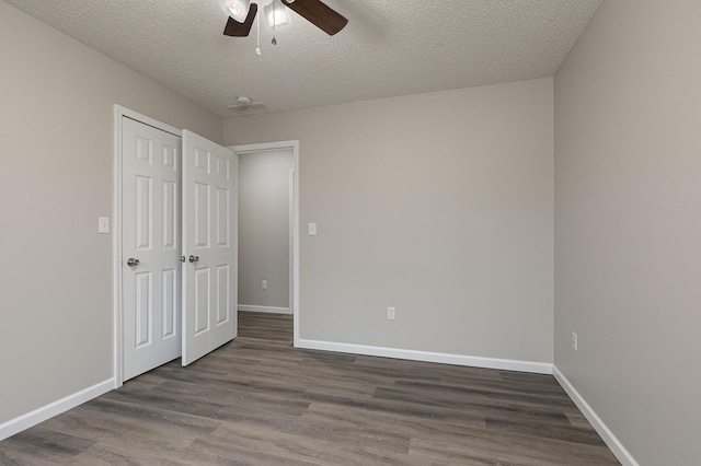 unfurnished bedroom with ceiling fan, a textured ceiling, and hardwood / wood-style flooring