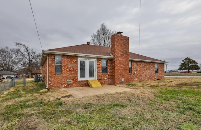 rear view of property featuring a yard and a patio