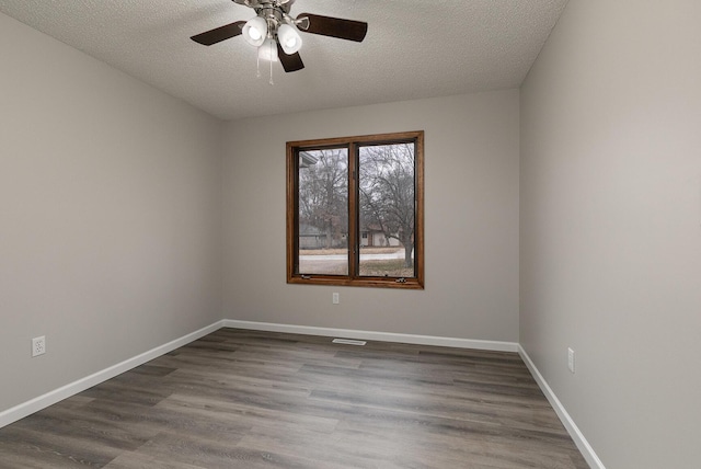 empty room featuring ceiling fan, wood-type flooring, and a textured ceiling