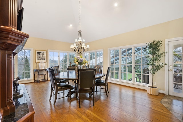 dining area featuring wood-type flooring and an inviting chandelier