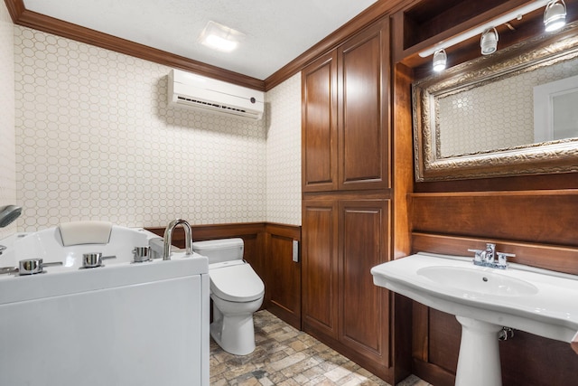 bathroom featuring an AC wall unit, wooden walls, toilet, and ornamental molding