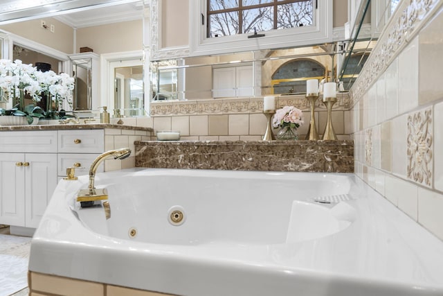 bathroom with crown molding and a tub