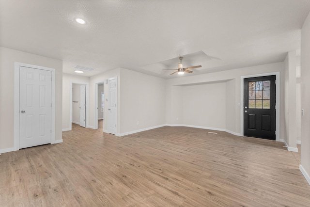 unfurnished living room with ceiling fan and light wood-type flooring