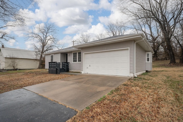 view of front of house featuring a garage and a front lawn