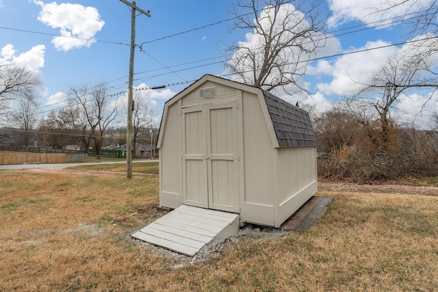 view of outbuilding with a yard