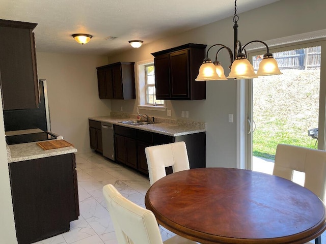 kitchen featuring pendant lighting, dishwasher, an inviting chandelier, sink, and dark brown cabinetry