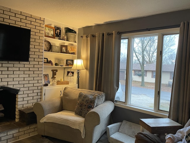 sitting room featuring a fireplace and built in features