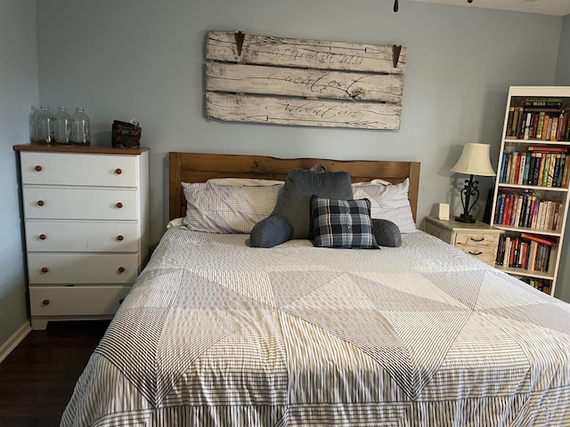 bedroom with dark hardwood / wood-style flooring