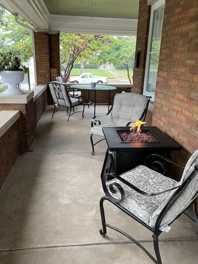 view of patio with covered porch and a fire pit