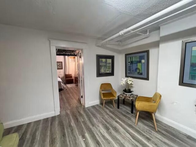 living area featuring hardwood / wood-style flooring and a textured ceiling