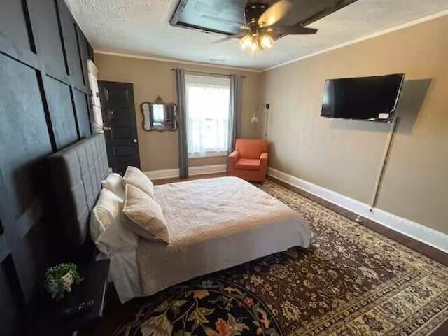 bedroom featuring hardwood / wood-style flooring, ceiling fan, and ornamental molding