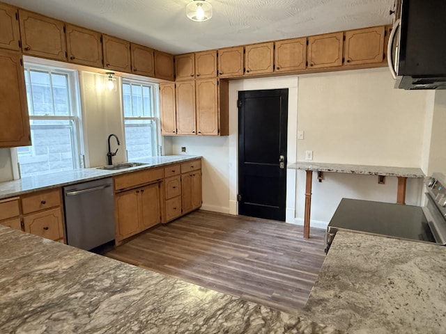 kitchen featuring dishwasher, sink, dark wood-type flooring, stove, and a textured ceiling