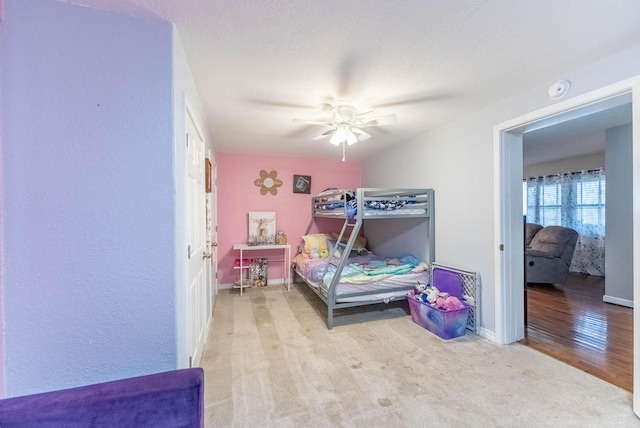 bedroom with ceiling fan and light colored carpet