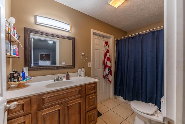 bathroom featuring tile patterned flooring, vanity, a textured ceiling, and toilet