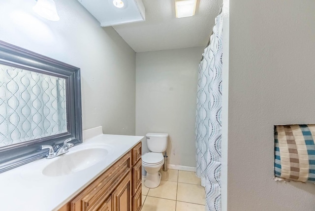 bathroom with tile patterned floors, vanity, and toilet