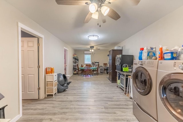 washroom with washer and dryer and light hardwood / wood-style flooring