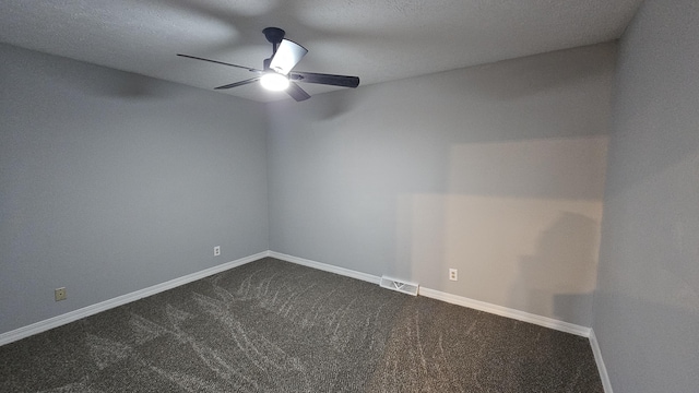 unfurnished room featuring dark colored carpet, ceiling fan, and a textured ceiling